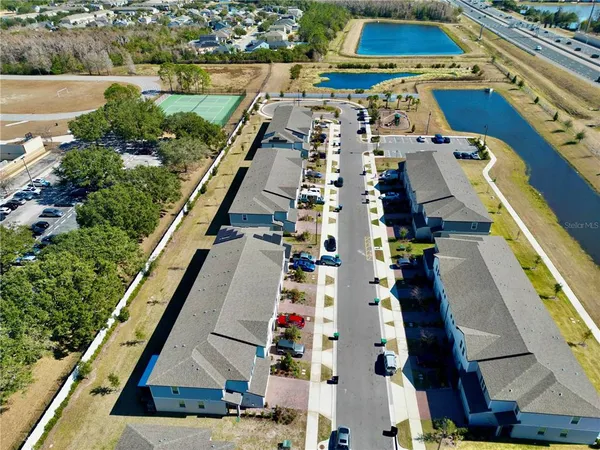 an aerial view of multiple houses with yard