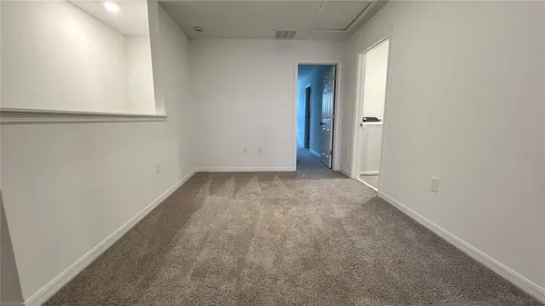 an empty room with a empty space and windows