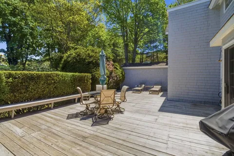 a view of a deck with table and chairs and wooden floor