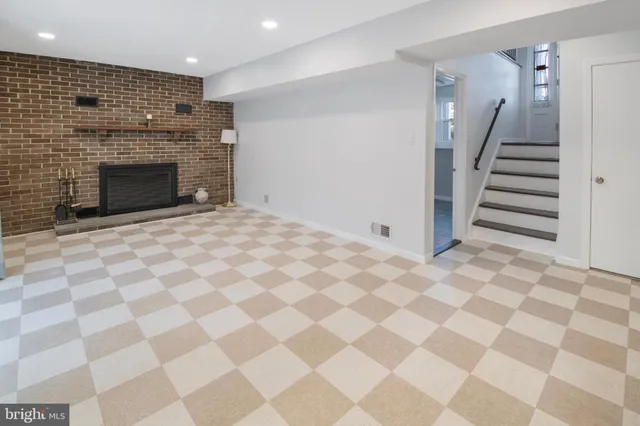 a view of an empty room with a fireplace