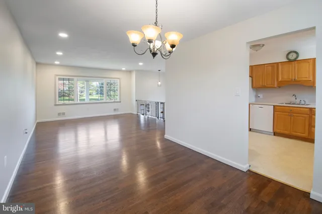 a view of a kitchen with wooden floor and a chandelier