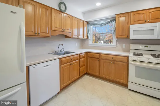 a kitchen with sink a microwave and cabinets
