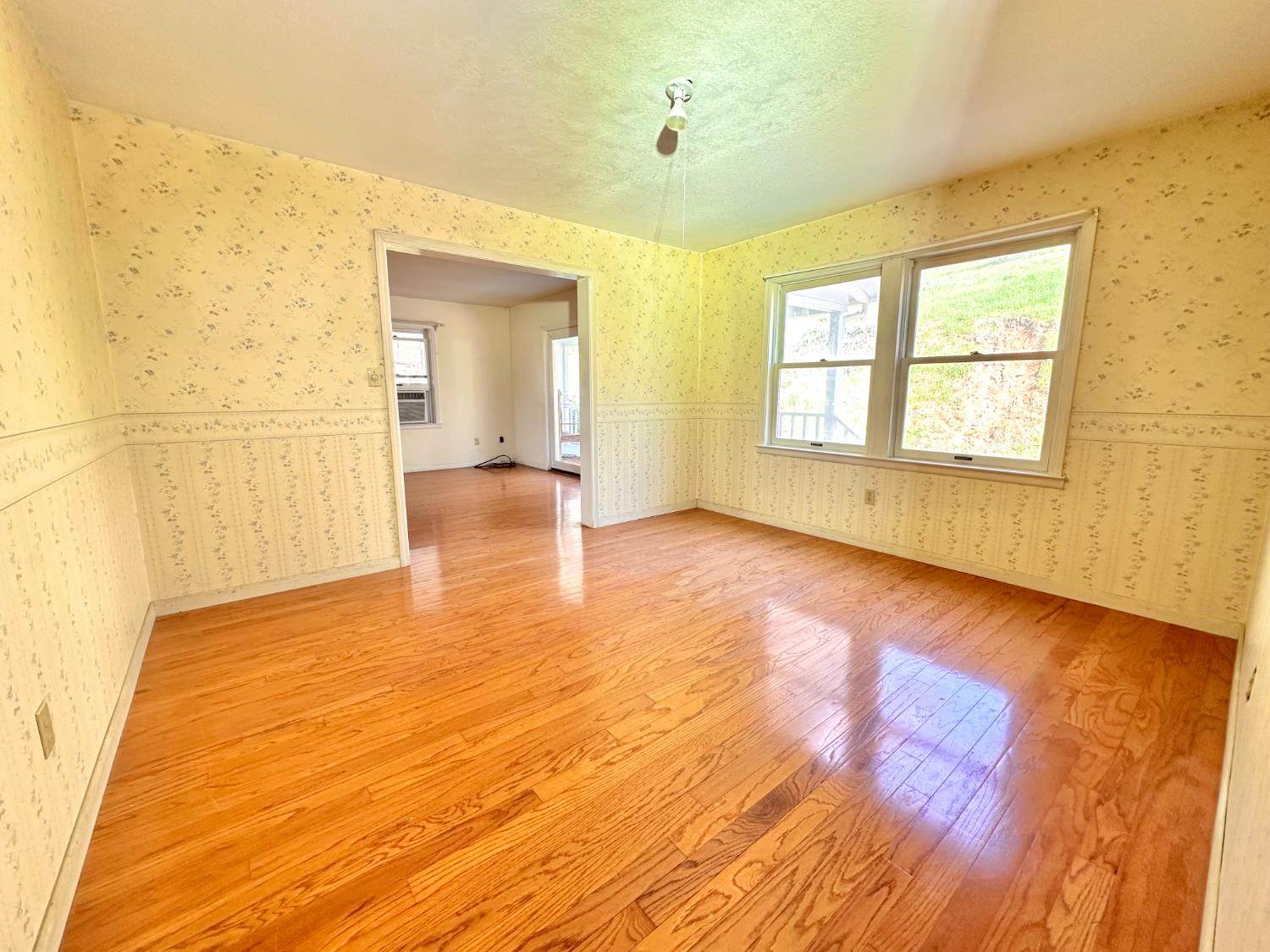 1933 Appaloosa Road Angels Camp, CA 95222 - Photo 14 of 75 a view of an empty room with wooden floor and a window