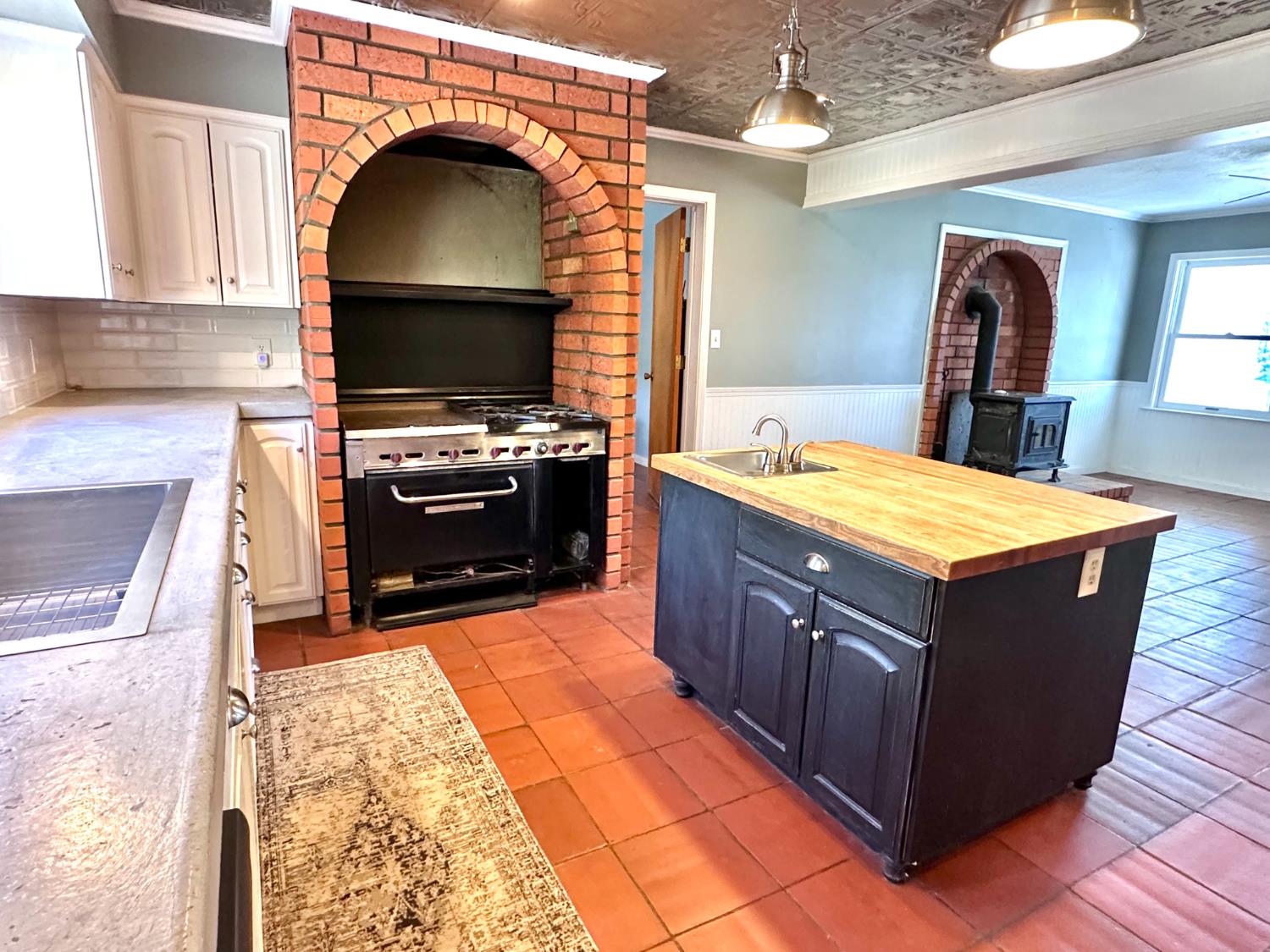 1933 Appaloosa Road Angels Camp, CA 95222 - Photo 16 of 75 a kitchen with kitchen island granite countertop a stove a sink and a refrigerator