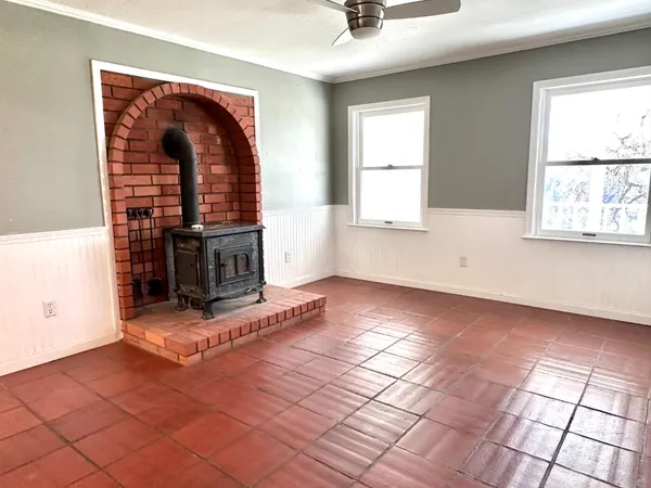 a view of a kitchen with kitchen island granite countertop a refrigerator and a stove