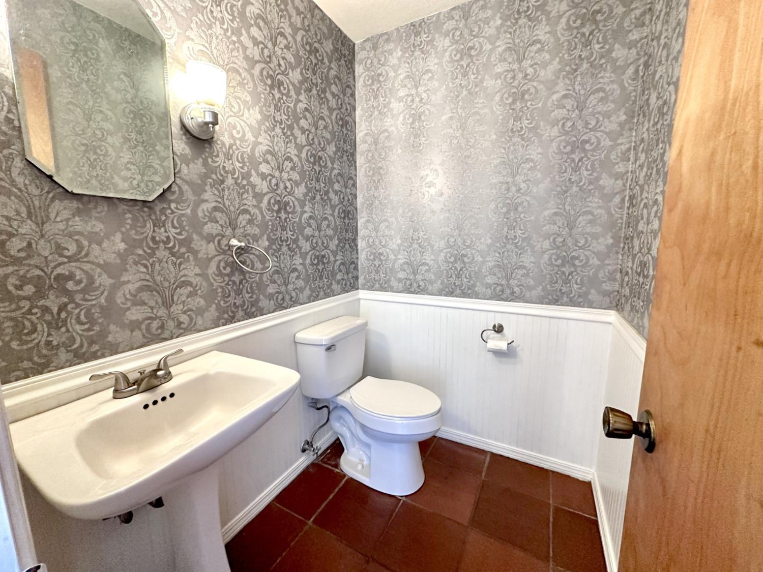 1933 Appaloosa Road Angels Camp, CA 95222 - Photo 25 of 75 a bathroom with a sink toilet and a mirror