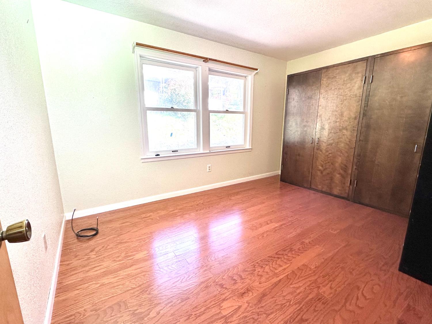1933 Appaloosa Road Angels Camp, CA 95222 - Photo 29 of 75 an empty room with wooden floor and windows