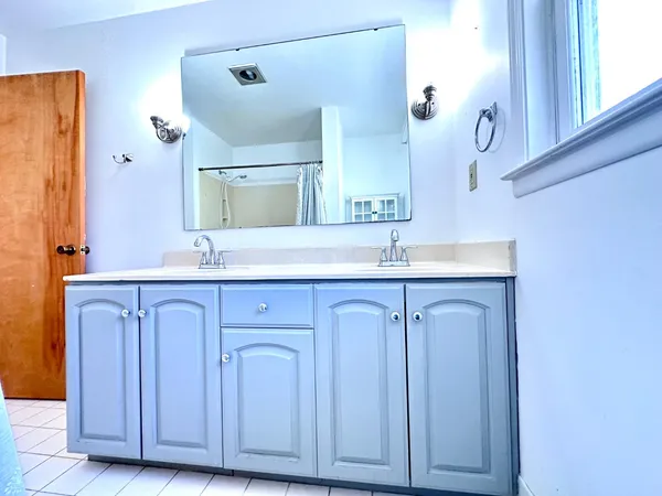 a bathroom with a granite countertop sink and a mirror