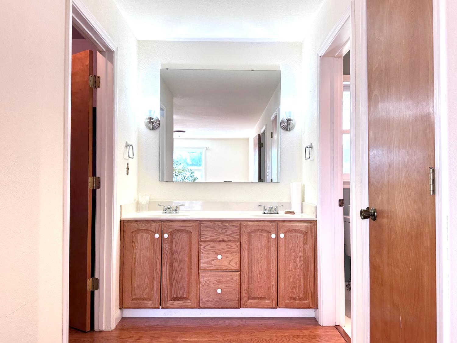 1933 Appaloosa Road Angels Camp, CA 95222 - Photo 38 of 75 a bathroom with a granite countertop sink and a mirror
