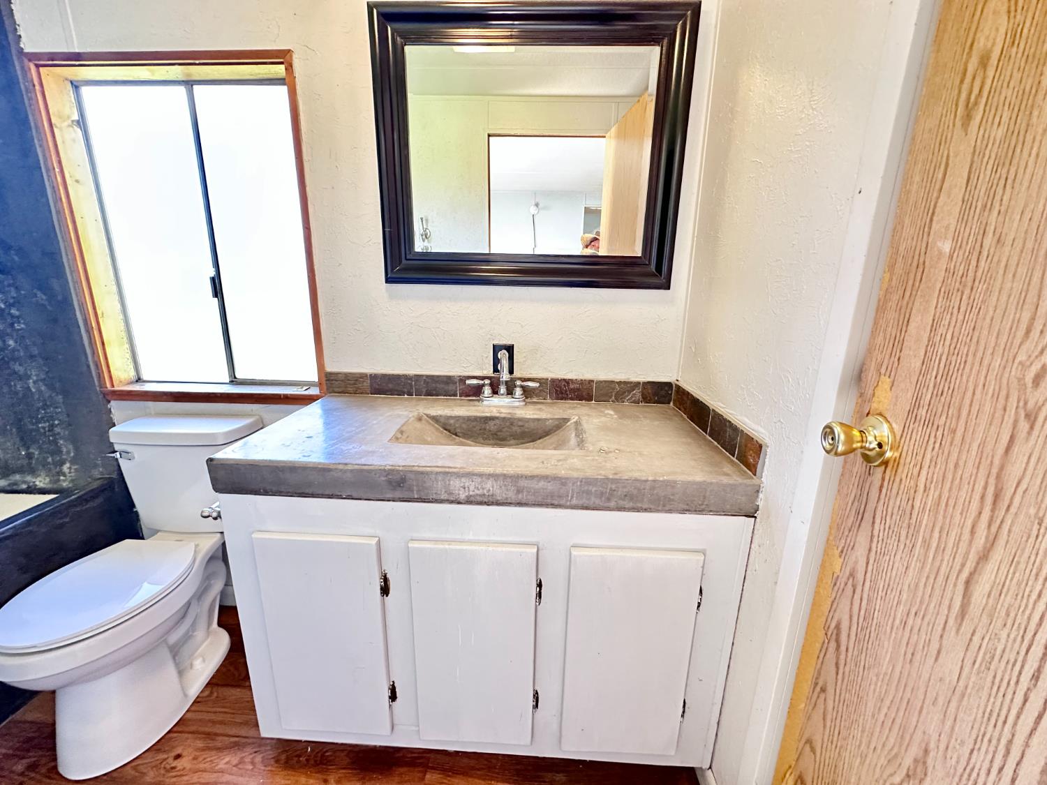 1933 Appaloosa Road Angels Camp, CA 95222 - Photo 67 of 75 a bathroom with a granite countertop toilet sink and mirror