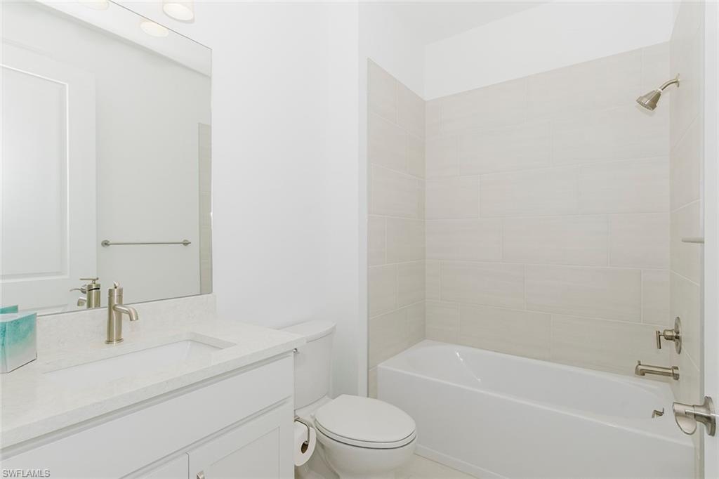 1954 Fresno Avenue Naples, FL 34120 - Photo 15 of 40 a bathroom with a sink a toilet and a bathtub