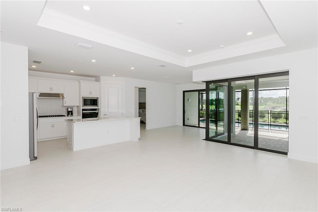 1954 Fresno Avenue Naples, FL 34120 - Photo 19 of 40 a view of an empty room with kitchen