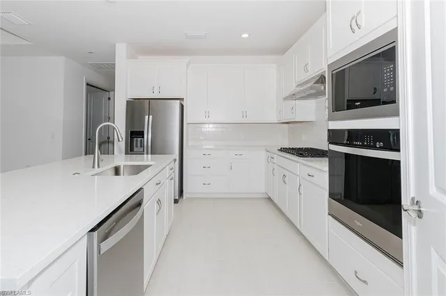 a kitchen with a sink stove and refrigerator
