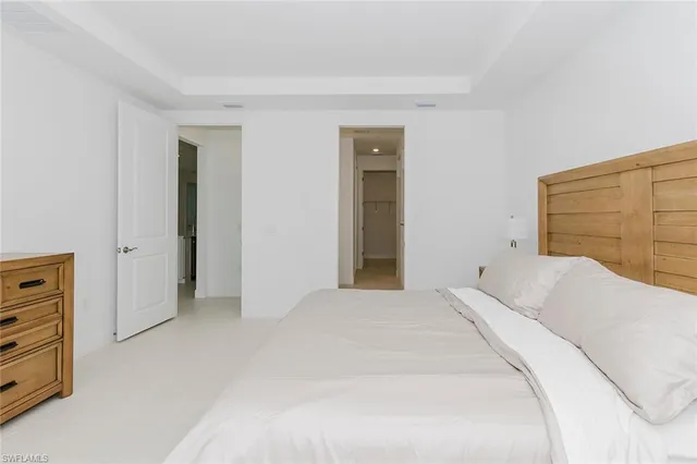 a bedroom with a bed and cabinets