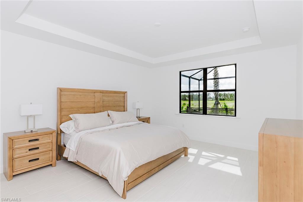 1954 Fresno Avenue Naples, FL 34120 - Photo 28 of 40 a bedroom with a bed and a window