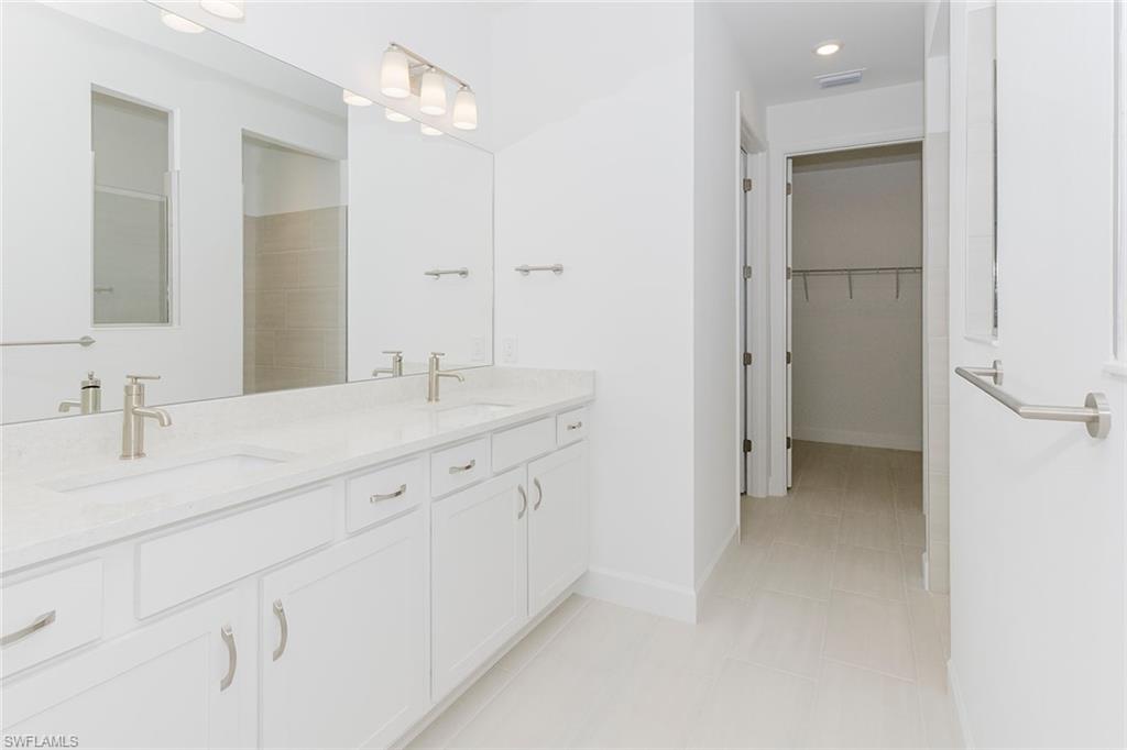 1954 Fresno Avenue Naples, FL 34120 - Photo 29 of 40 a bathroom with a sink and a mirror