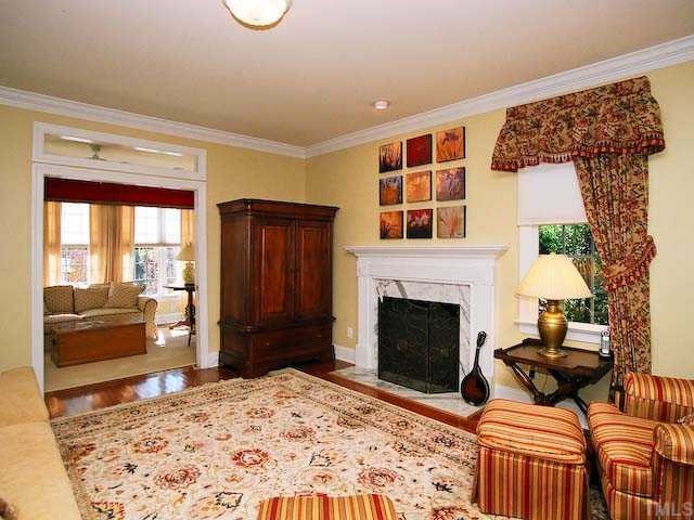 Designer living room. Features are crown moldings and pocket doors. Gleaming hardwoods and landscaped views. Living Room