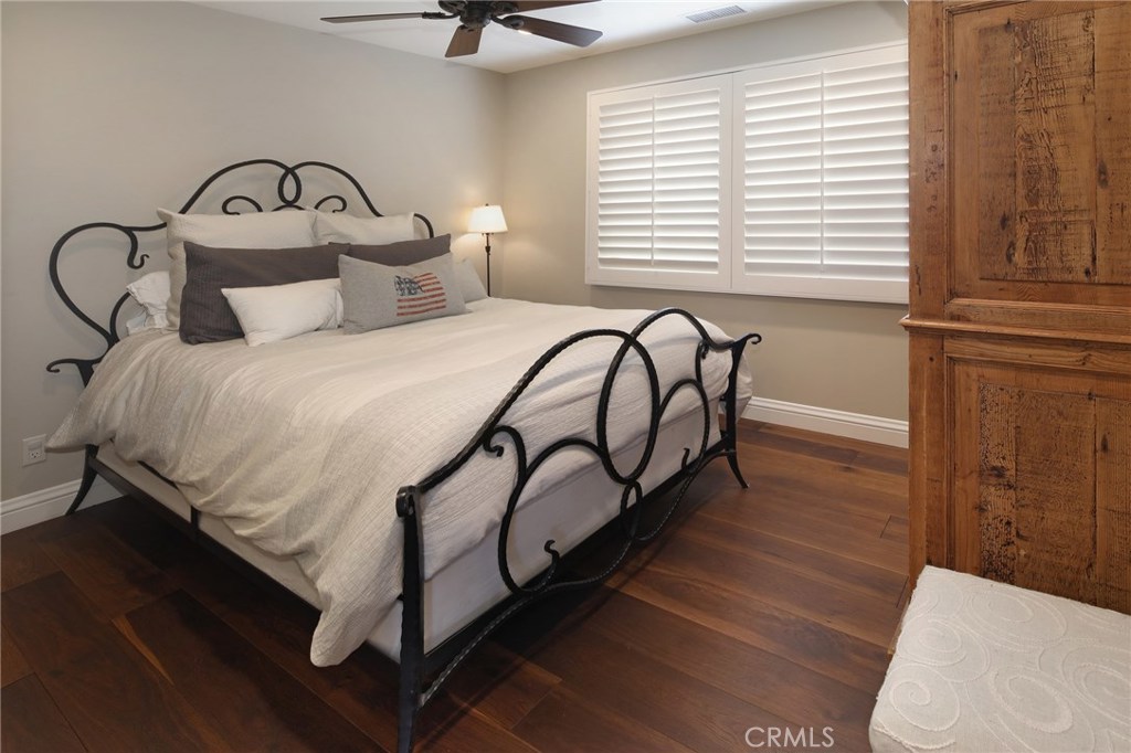 23711 Colima Bay Dana Point, CA 92629 - Photo 18 of 45 a bedroom with a bed and a dresser with wooden floor
