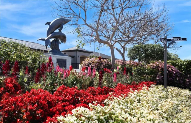 a view of a street with flower plants in front of it