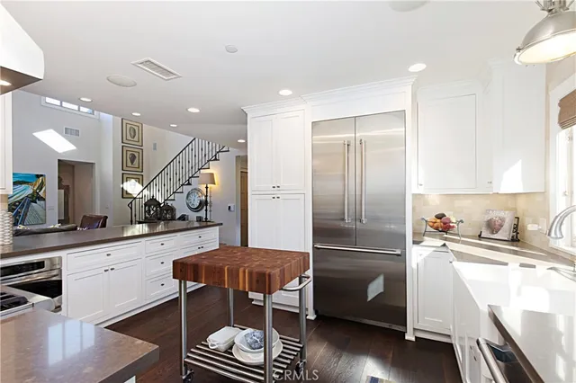 a kitchen with a sink stainless steel appliances and cabinets