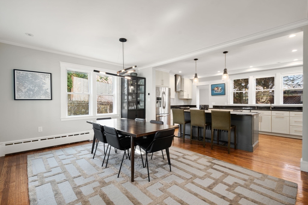 89 Prospect Street Newton, MA 02465 - Photo 11 of 31 a dining hall with stainless steel appliances kitchen island granite countertop a dining table chairs and view living room