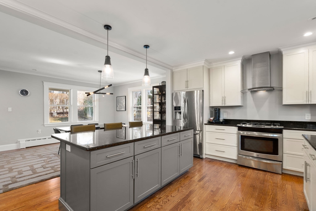 89 Prospect Street Newton, MA 02465 - Photo 15 of 31 a large kitchen with granite countertop a stove and a sink