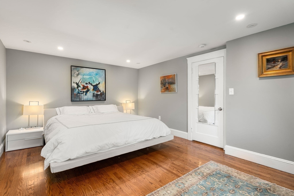 89 Prospect Street Newton, MA 02465 - Photo 20 of 31 a bedroom with a large bed and a painting on the wall