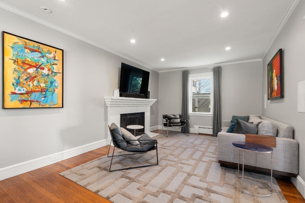 89 Prospect Street Newton, MA 02465 - Photo 8 of 31 a living room with furniture a rug and a fireplace