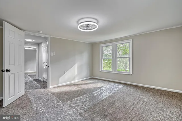 a view of an empty room with wooden roof