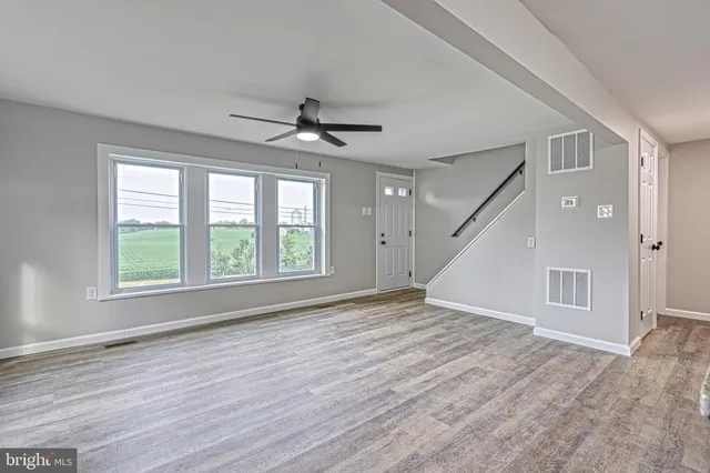 a large white kitchen with granite countertop a refrigerator and a stove