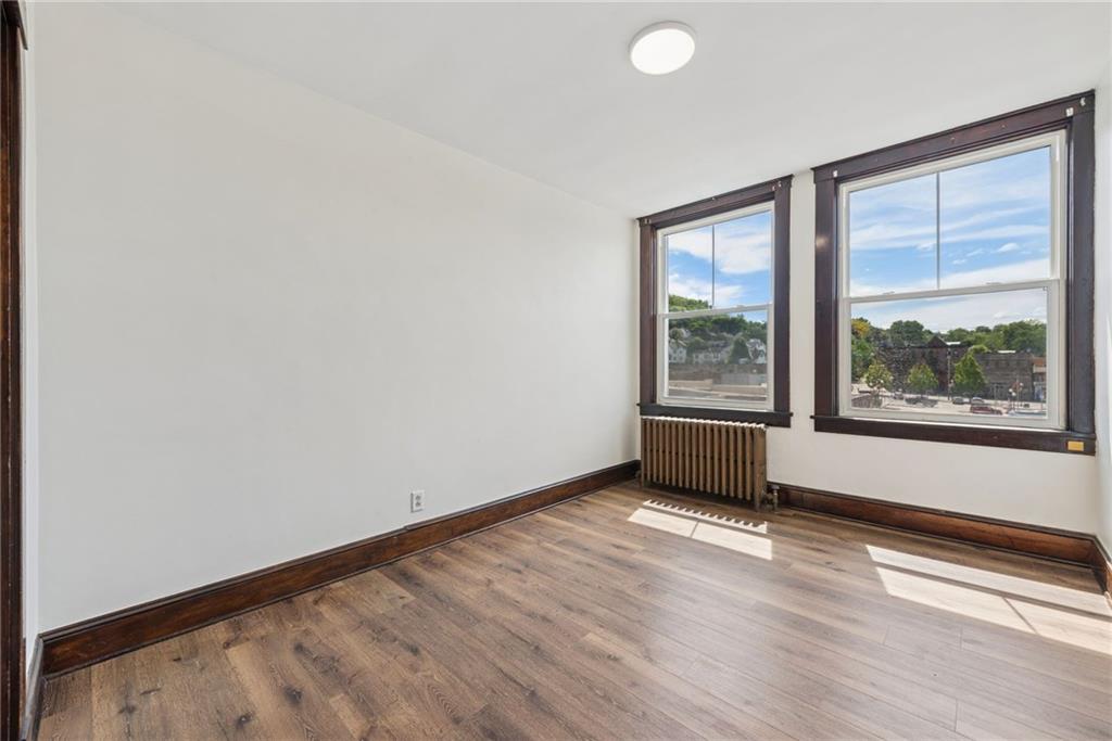 206 North Warren Avenue Apollo, PA 15613 - Photo 17 of 23 an empty room with wooden floor and windows