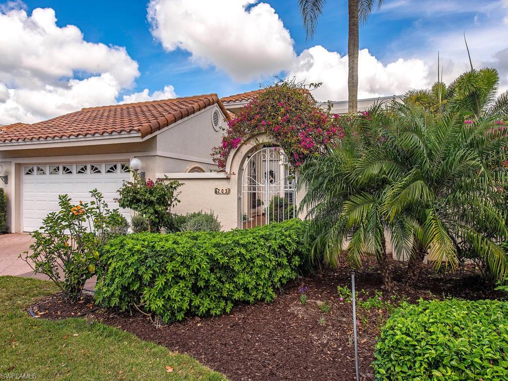 203 Via Napoli Naples, FL 34105 - Photo 11 of 13 a front view of a house with garden