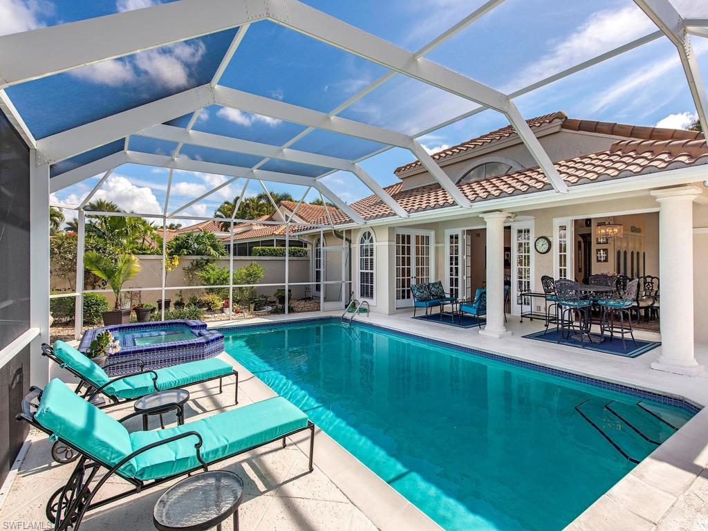 203 Via Napoli Naples, FL 34105 - Photo 12 of 13 a view of a chairs and table in the patio