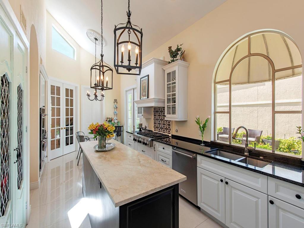 203 Via Napoli Naples, FL 34105 - Photo 3 of 13 a kitchen with sink cabinets and outdoor view