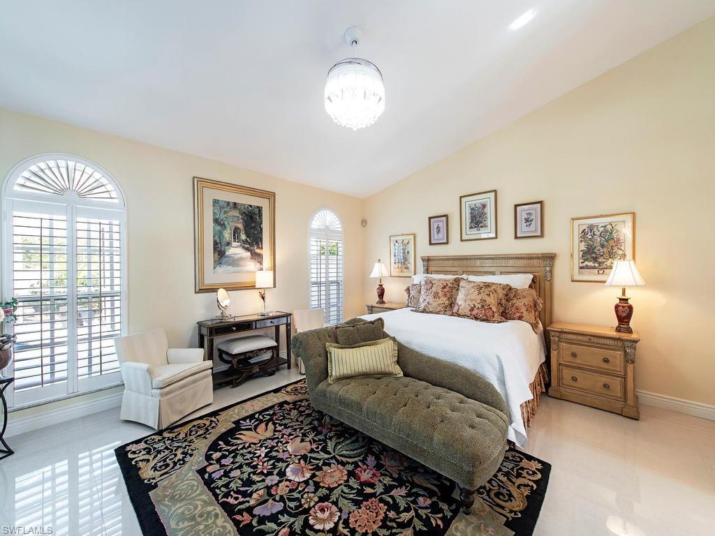 203 Via Napoli Naples, FL 34105 - Photo 6 of 13 a bed room with a bed and a couch