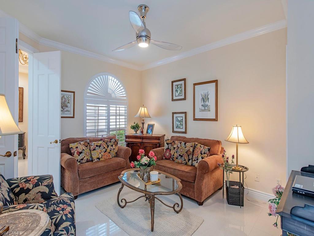 203 Via Napoli Naples, FL 34105 - Photo 10 of 13 a living room with furniture and a large window