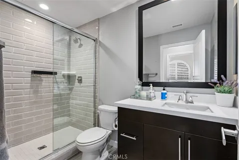 a bathroom with a sink a toilet and shower