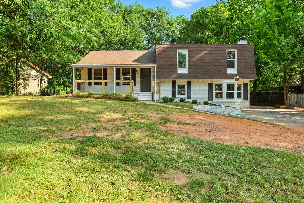 a front view of a house with a yard