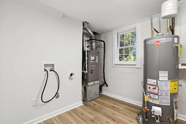 a bathroom with a granite countertop shower a sink and a window