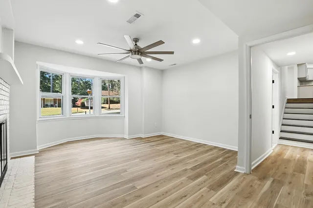 wooden floor in an empty room with a window