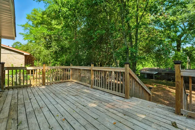 a view of balcony with wooden floor and fence