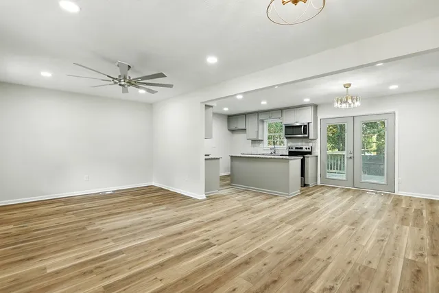 a view of kitchen with granite countertop cabinets and refrigerator