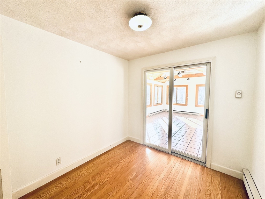 45 Beverly Road Brookline, MA 02467 - Photo 12 of 42 an empty room with wooden floor and windows