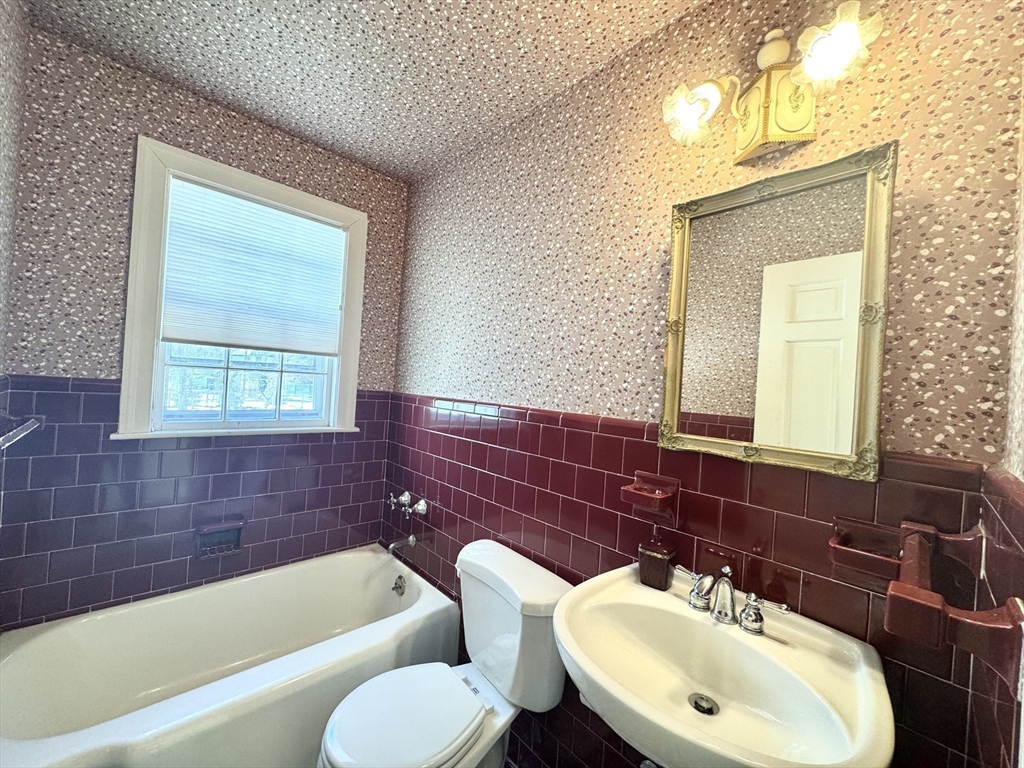 45 Beverly Road Brookline, MA 02467 - Photo 17 of 42 a bathroom with a sink mirror bathtub and window