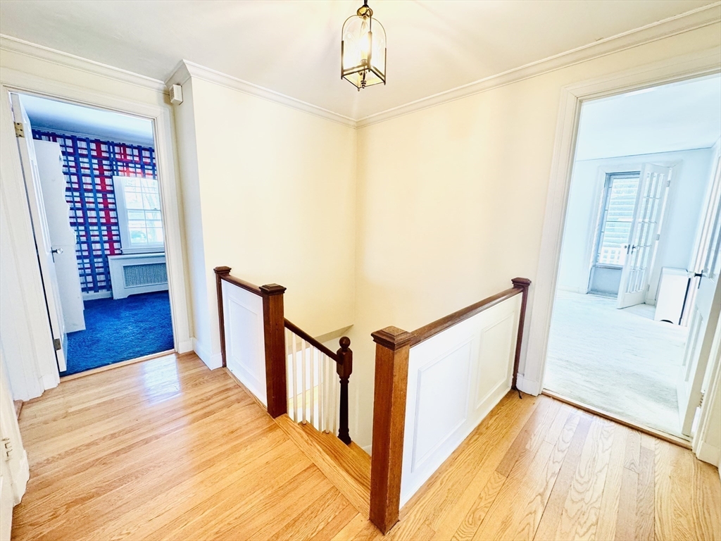 45 Beverly Road Brookline, MA 02467 - Photo 18 of 42 a view of a hallway with wooden floor and stairs