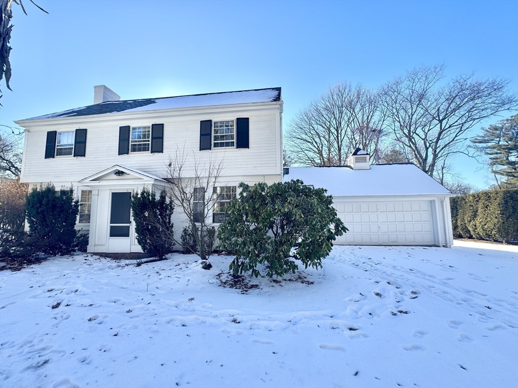 45 Beverly Road Brookline, MA 02467 - Photo 36 of 42 a front view of a house with a yard and garage