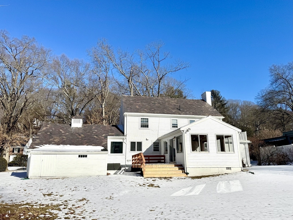 45 Beverly Road Brookline, MA 02467 - Photo 38 of 42 a view of a white house with a yard covered in snow