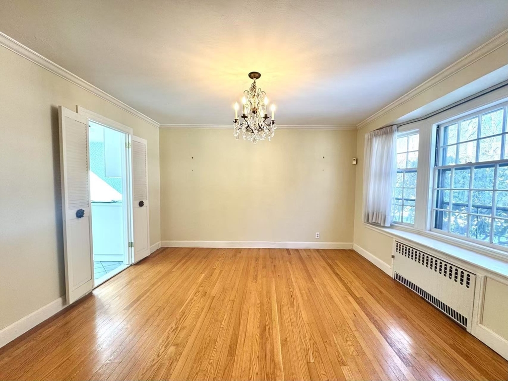 45 Beverly Road Brookline, MA 02467 - Photo 7 of 42 wooden floor in an empty room with a window