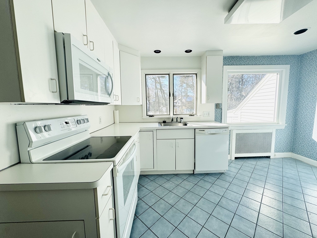 45 Beverly Road Brookline, MA 02467 - Photo 8 of 42 a kitchen with a sink stove and cabinets