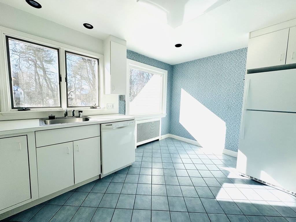 45 Beverly Road Brookline, MA 02467 - Photo 9 of 42 a view of a kitchen with a sink and windows